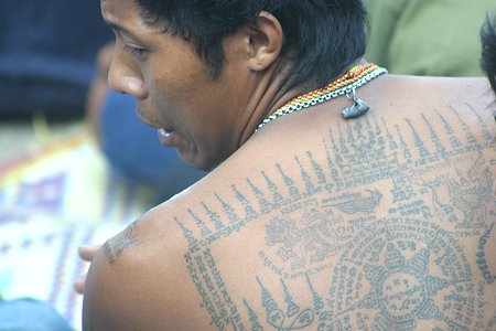 A Thai shows Khmer Sak Khmer Tattoo on his back during Thai Tattoo